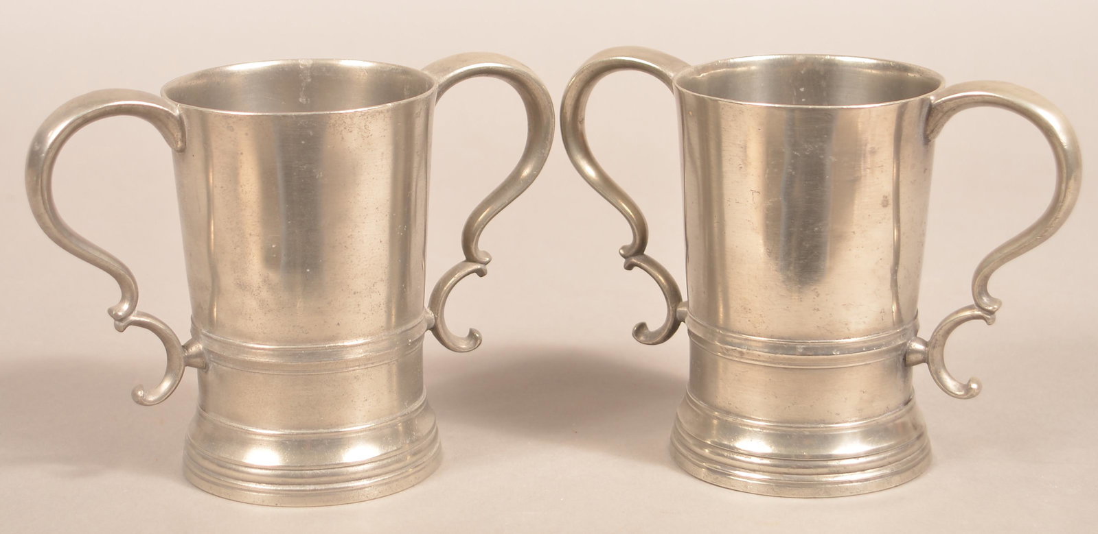 Two Timothy Boardman & Co. Pewter Church Cups.: Two Timothy Boardman & Co. Pewter Double-Handled Church Cups. (Hartford, CT Circa 1825-1835). 5-1/2"h. Condition: Very good with minor wear.