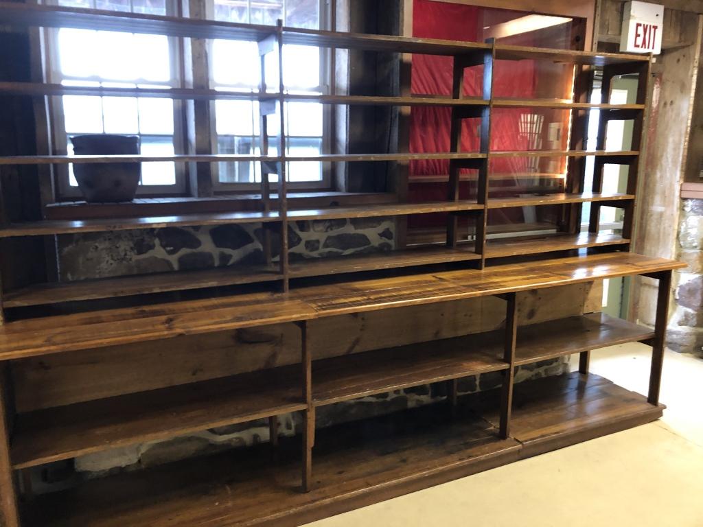 Pine 2-Part Step back Open Country Store: Display Shelves. Originally removed from Sprecher's Hardware Store, Ephrata. 128"L x 81"H x 26"D. Condition: Good, one section partially cut out in back because of post, slight modifications over time
