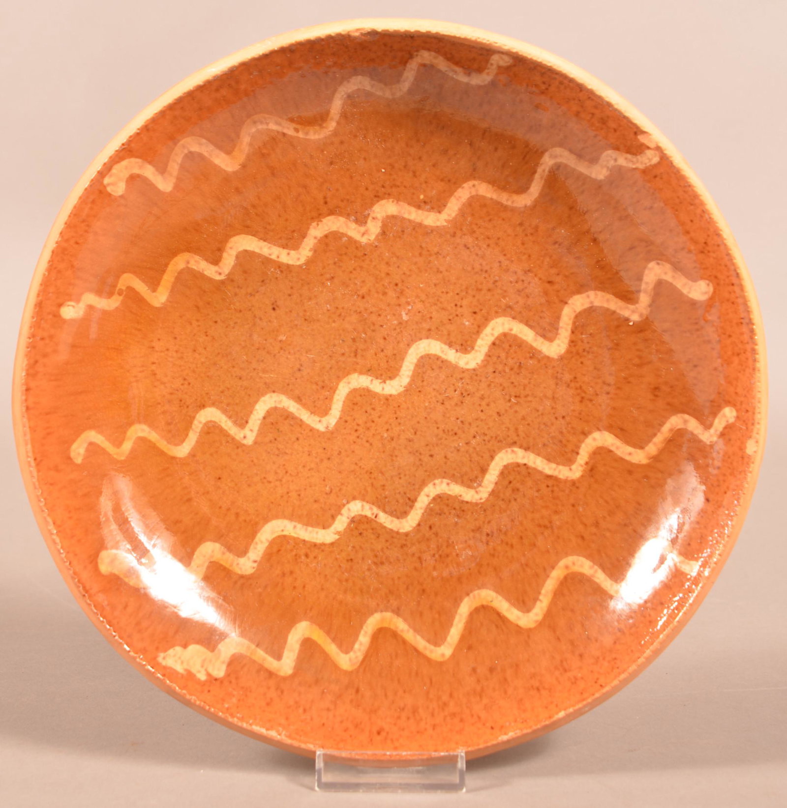 19th Century Slip-Decorated Redware Plate.: 19th Century Slip-Decorated Redware Plate. Unsigned, attributed to Willoughby Smith, Berks County, PA, Circa. 1865-1880. 10"diam. Condition: Good with a few edge chips.