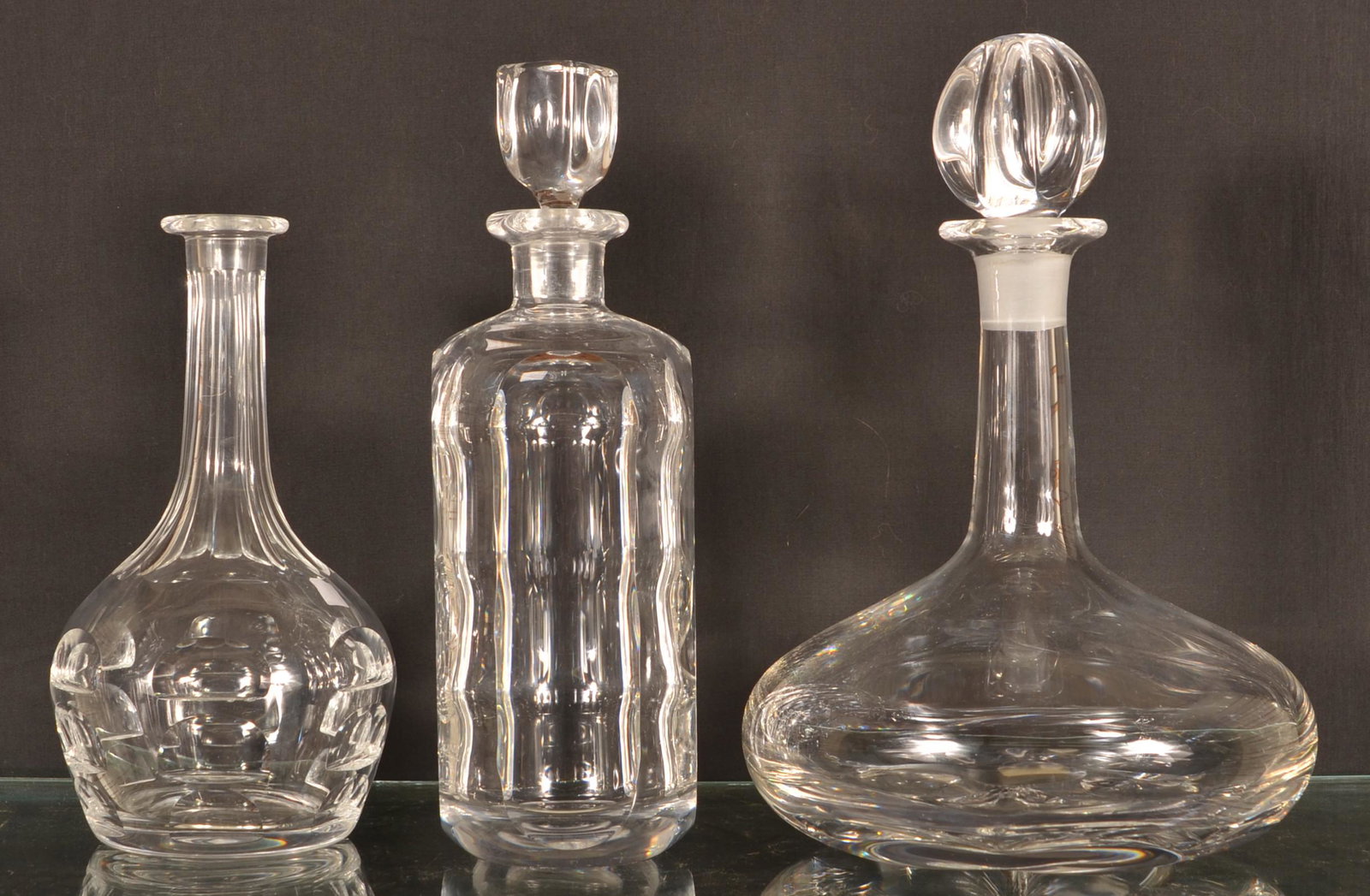 Three Various Orrefors Crystal Decanters.: Three Various Orrefors Crystal Decanters. Tallest 11-1/4"h. Condition: Very good, one missing the stopper.