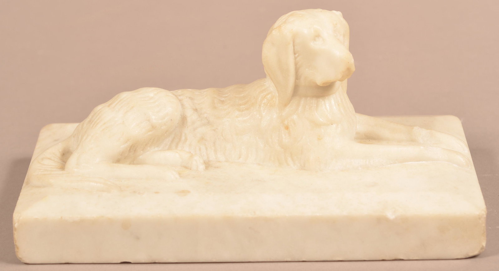 Antique Folk Art Carved Marble Reclining Dog Doorstop.: American 19th Century Folk Art Carved Marble Reclining Dog Doorstop. Eugene and the late Vera Charles, Lancaster, PA. 3-1/2"h. x 7-3/4"l. x 4-3/4"d. Condition: Good with minor wear and chips.