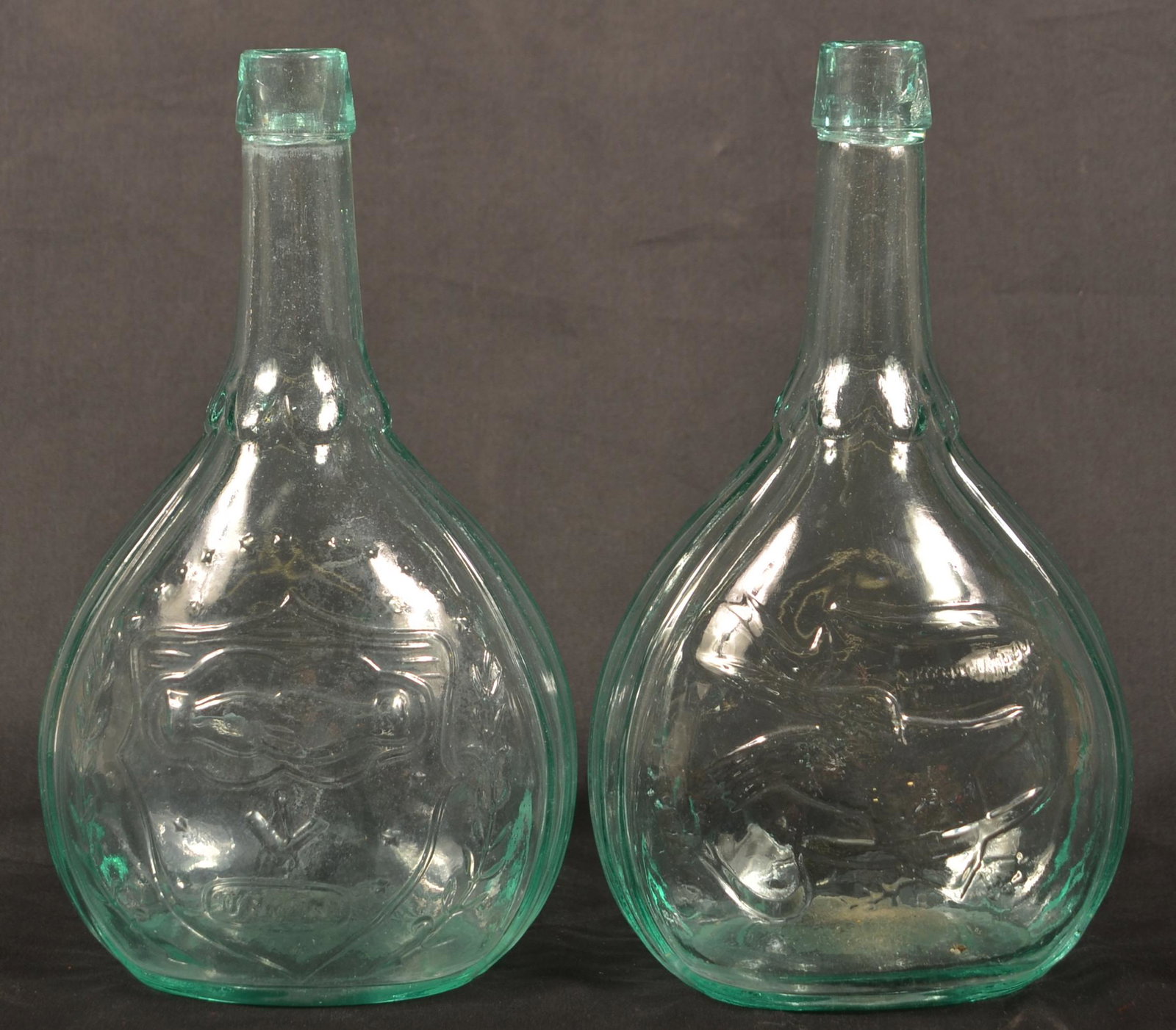 2 Aquamarine Eagle/Union Quart Size Calabash Bottles.: Two Aquamarine Eagle/Union Quart Size Calabash Bottles. Quart size with Masonic clasped hands in shield above "UNION" on obverse and Eagle facing right with banner on reverse. 9-1/2"h. Condition: Very