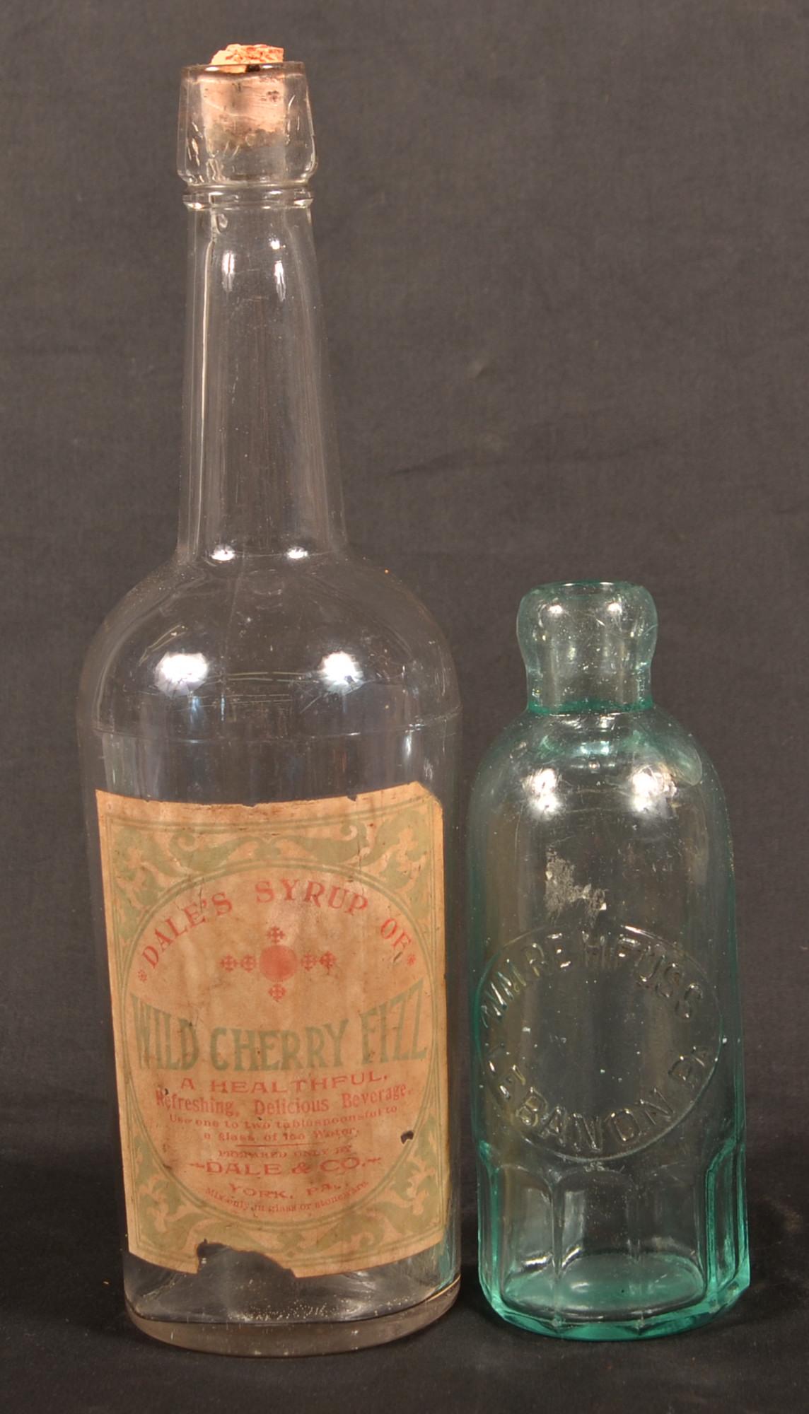 Two Glass Bottles with Pennsylvania Labels.: Two Glass Bottles with Pennsylvania Labels. Wild Cherry Fizz, Dale & Co., York, PA, 11-1/4"h. and Wm. Rehfuse, Lebanon, PA embossed label aquamarine brewery bottle, 6-3/4"h. Condition: Good with wear.