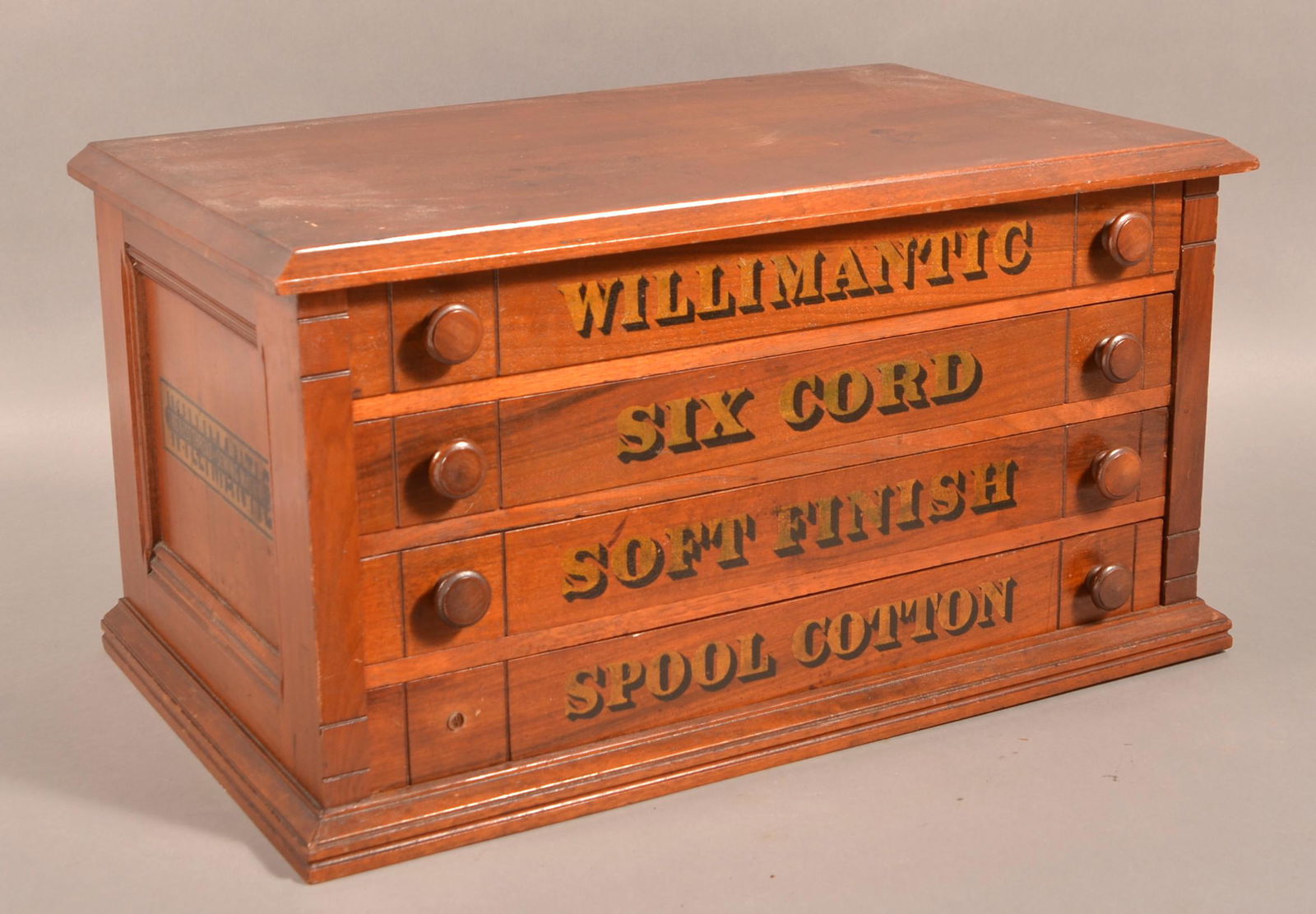 Victorian Willimantic Four Drawer Walnut Spool Cabinet.: Victorian Willimantic Four Drawer Walnut Spool Cabinet. Advertising on all four sides. 13-1/2"h. x 25"w. x 15"d. Condition: Very good with use wear. Cardboard advertising panel is detached. Missing on