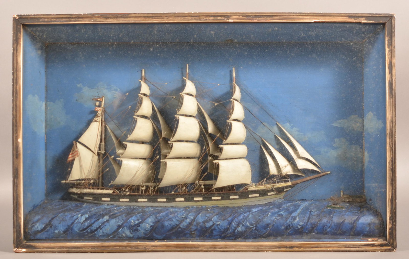 Antique Folk Art American Clipper Ship Diorama.: Antique Folk Art American Clipper Ship Diorama. Four masts with a full complement of sails rendered in wood, rigging to scale, set on a painted background, with a textured sea. 19"h. x 30" overall. Co