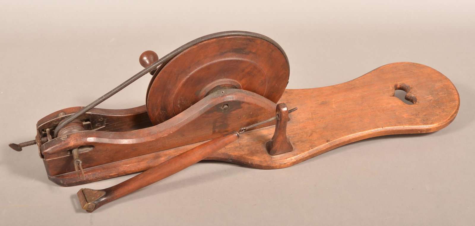 19th Century Wooden Apple Peeler.: 19th Century Wooden Apple Peeler. Crank action with shaped plank base having a heart cut-out. 30-1/2"l. overall. Condition: Good with use wear.