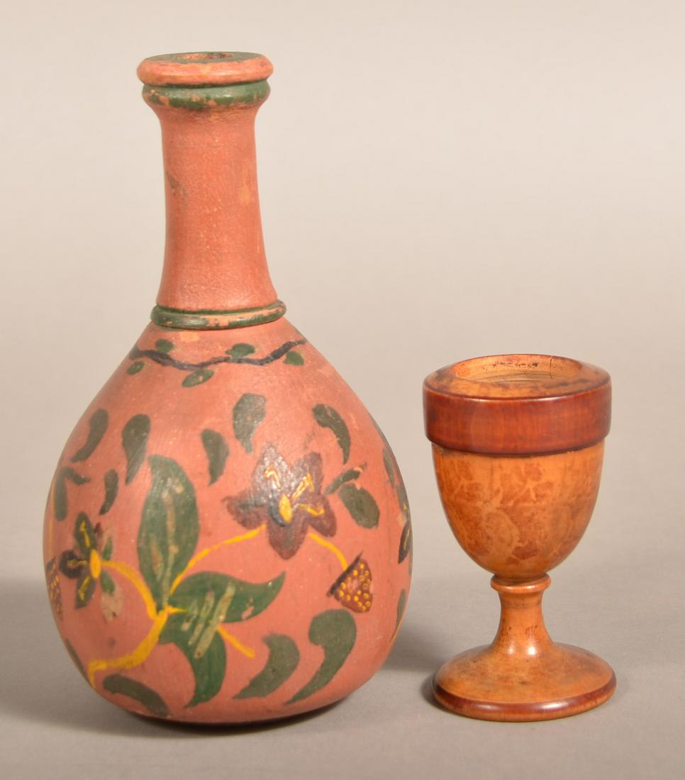 Two Pieces of Painted Wood Turnings.: Two Pieces of Painted Wood Turnings. Sponge decorated saffron cup (missing lid), 3-1/8"h. and floral and strawberry decorated bottle form bud vase, 6-1/2"h. Eugene and the late Vera Charles collection