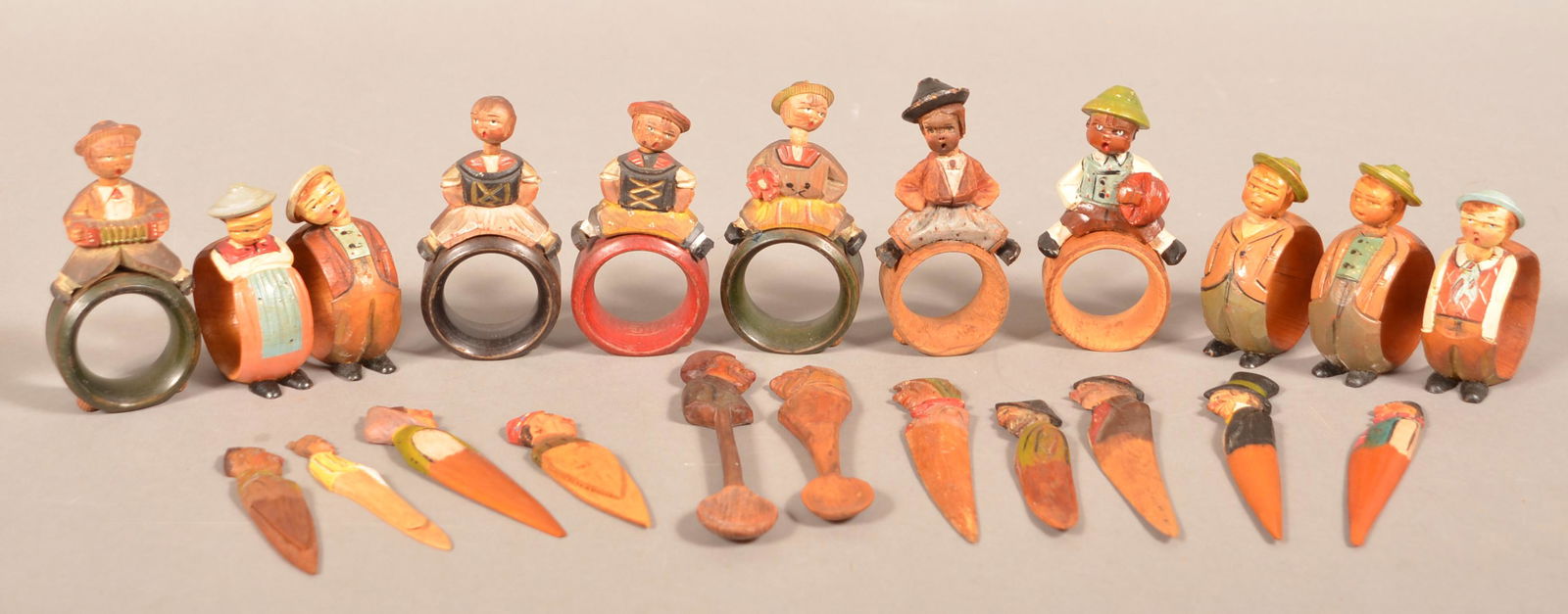 22 Anri Italian Hand-Carved Wood Figural Items.: 22 Anri Italian Hand-Carved Wood Figural Items. 11 napkin rings, 6 letter openers, 3 bookmarks and 2 spoons. Tallest 3-1/2"h. Condition: Good with minor wear.