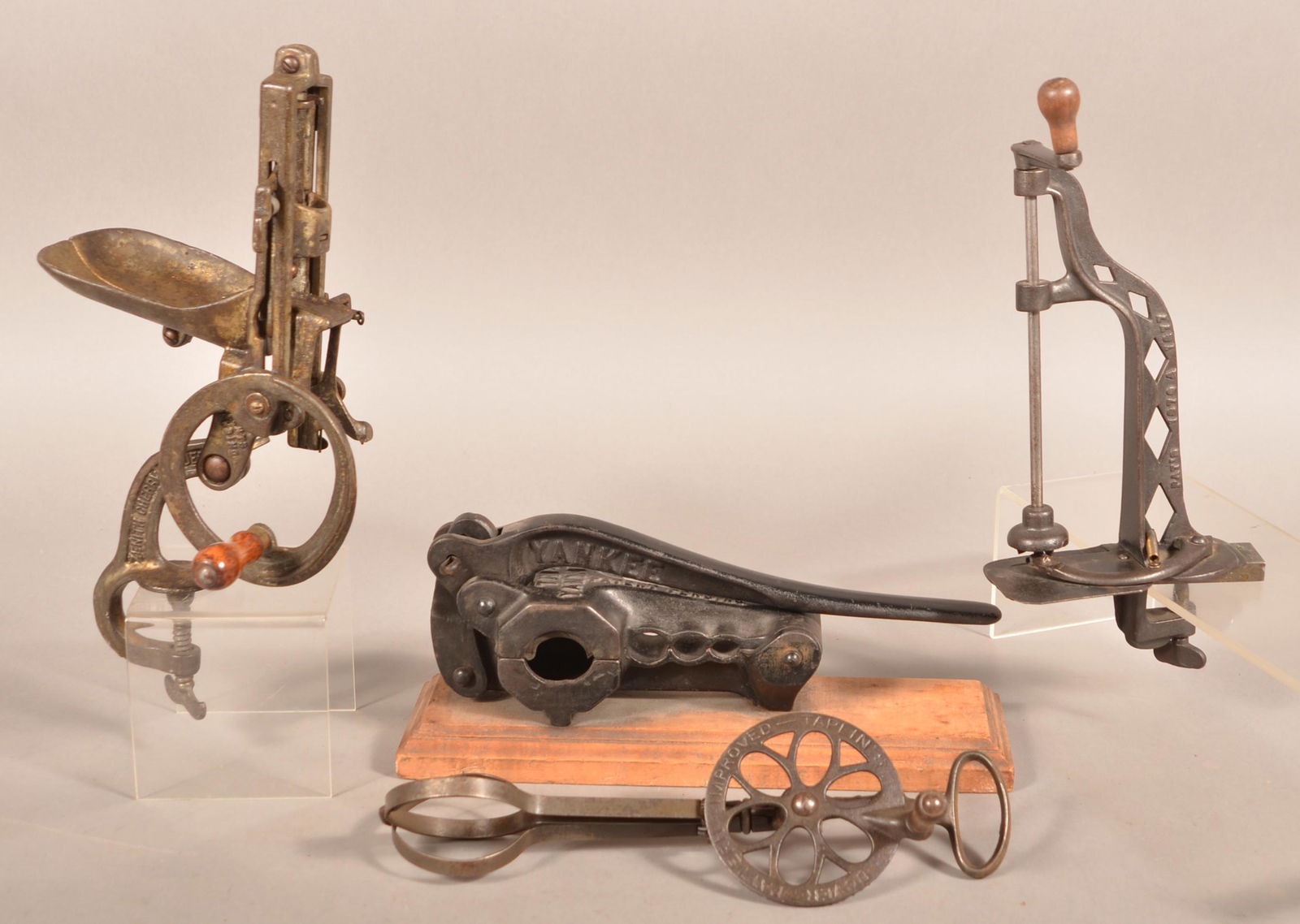 Four Various Antique Metal Utensils.: Four Various Antique Metal Utensils. Cork press, apple peeler, mixer and cherry pitter. Largest 10"h. Condition: Good with use wear.