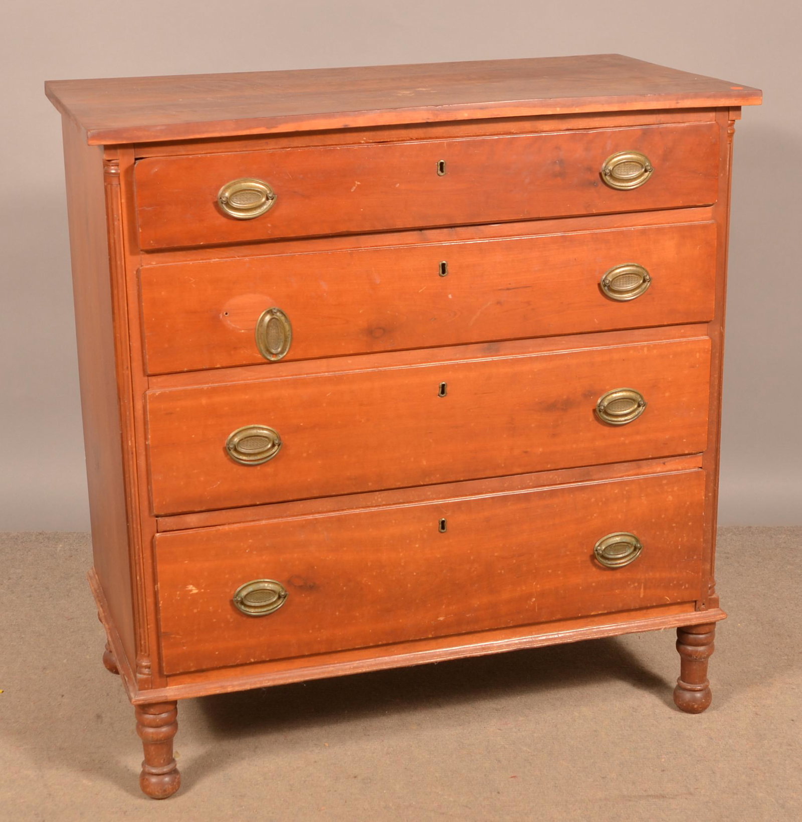 American Chippendale Cherry Chest of Drawers.: American Chippendale Cherry Chest of Drawers. Plank top, four full width lip molded dovetailed drawers, fluted quarter columns, molded base and replaced turned feet. 42"h. x 40-1/2"w. x 22"d. Conditio