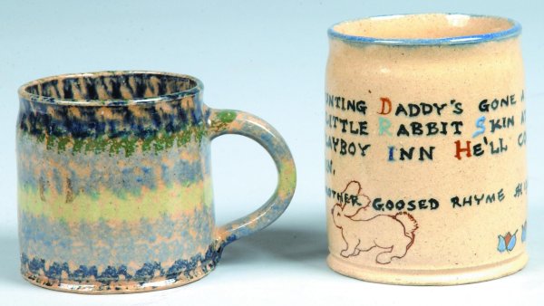 Two Left Handed Russell Henry Pottery Mugs, one blu: Two Left Handed Russell Henry Pottery Mugs, one blue and green sponged decorations, other picturing rabbit and rhyme, inscribed on bottom Henry's name and dates of '72 etc., approx. 3"h., and 3-3/4"h.