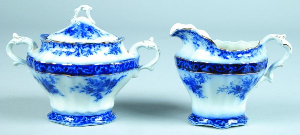 Flow Blue "Touraine" Covered Sugar Bowl and Cream: Flow Blue "Touraine" Covered Sugar Bowl and Cream Pitcher, printed makers mark, covered sugar bowl 5-3/4"h., cream pitcher 5-1/4"h., (good condition).