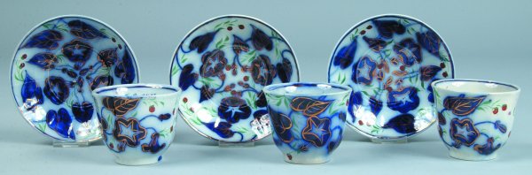 Three Gaudy Ironstone 'Morning Glory" Paneled Hand: Three Gaudy Ironstone 'Morning Glory" Paneled Handleless Cups and Saucers with strawberry decoration, unmarked, cups 3"h., saucers 5-7/8"diam., (two cups with chip, otherwise good condition).
