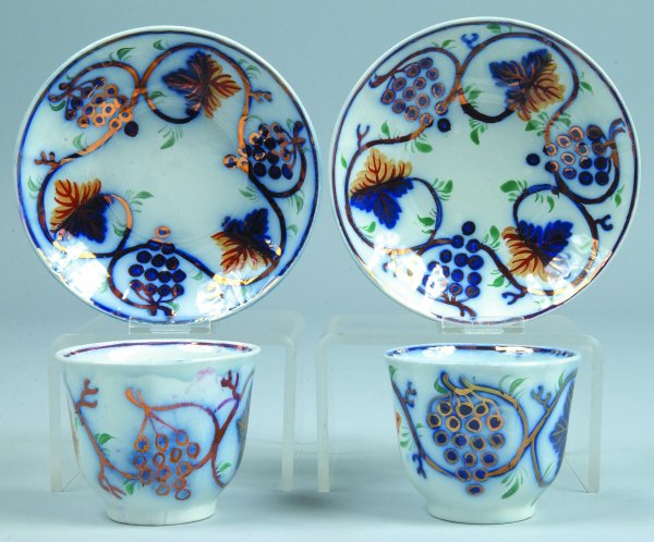 Two Gaudy Ironstone "Grape and Vine" Handleless Cu: Two Gaudy Ironstone "Grape and Vine" Handleless Cups and Saucers, saucers impressed with initial P, cups 3"h., saucers 5-7/8"diam, (good condition).