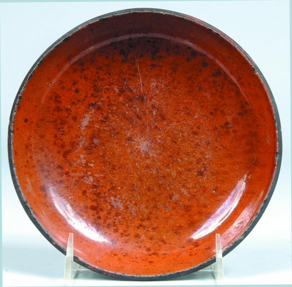 Redware Plate, round form, orange with black spatt: Redware Plate, round form, orange with black spatter, 1-¼"h. x 7"dia., (rim chips, hairlines).