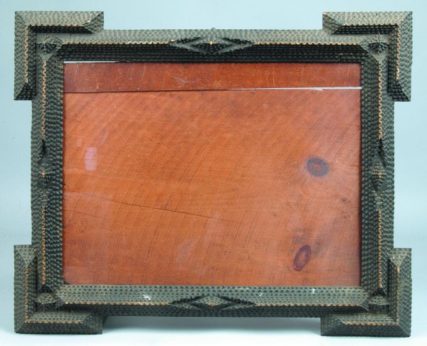 Tramp Art Picture Frame, wood frame with geometric: Tramp Art Picture Frame, wood frame with geometric patterns and applied serrated edged tiers, painted black with gold highlights, 26"h. x 21-1/2"w., (minor losses).