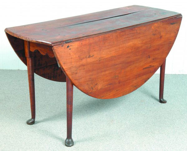 Queen Anne Cherry Drop Leaf Table with oval drop l: Queen Anne Cherry Drop Leaf Table with oval drop leaves, serpentine skirt and turned legs with pad feet, (restorations), 28-1/2" h. x 53" l. x 19-1/2" w., leaves 19" each.