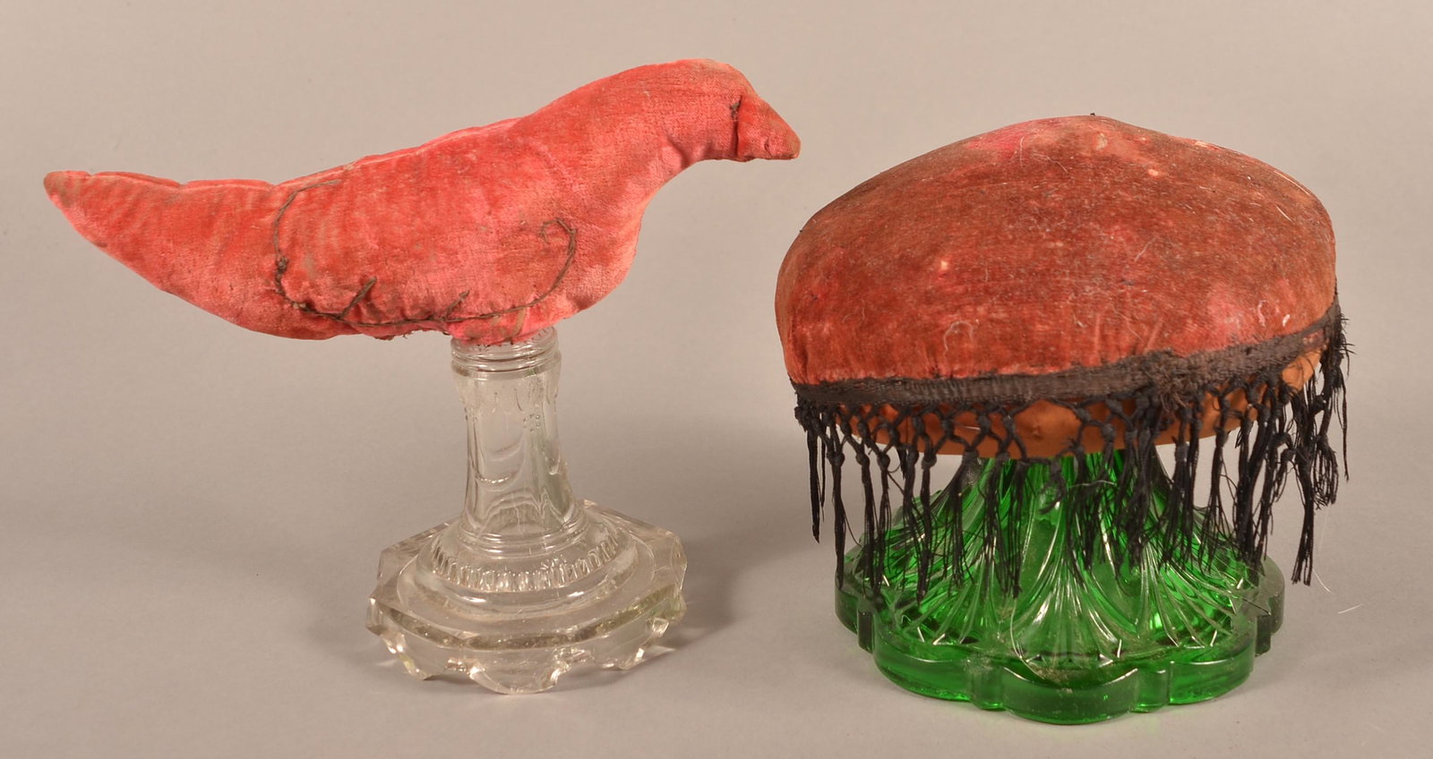 Two 19th century Make-Do Pin Cushions.: Two 19th century Make-Do Pin Cushions. Both are Mounted on glass fluid lamp bases. Tallest 8"h. Condition: Fair to good.
