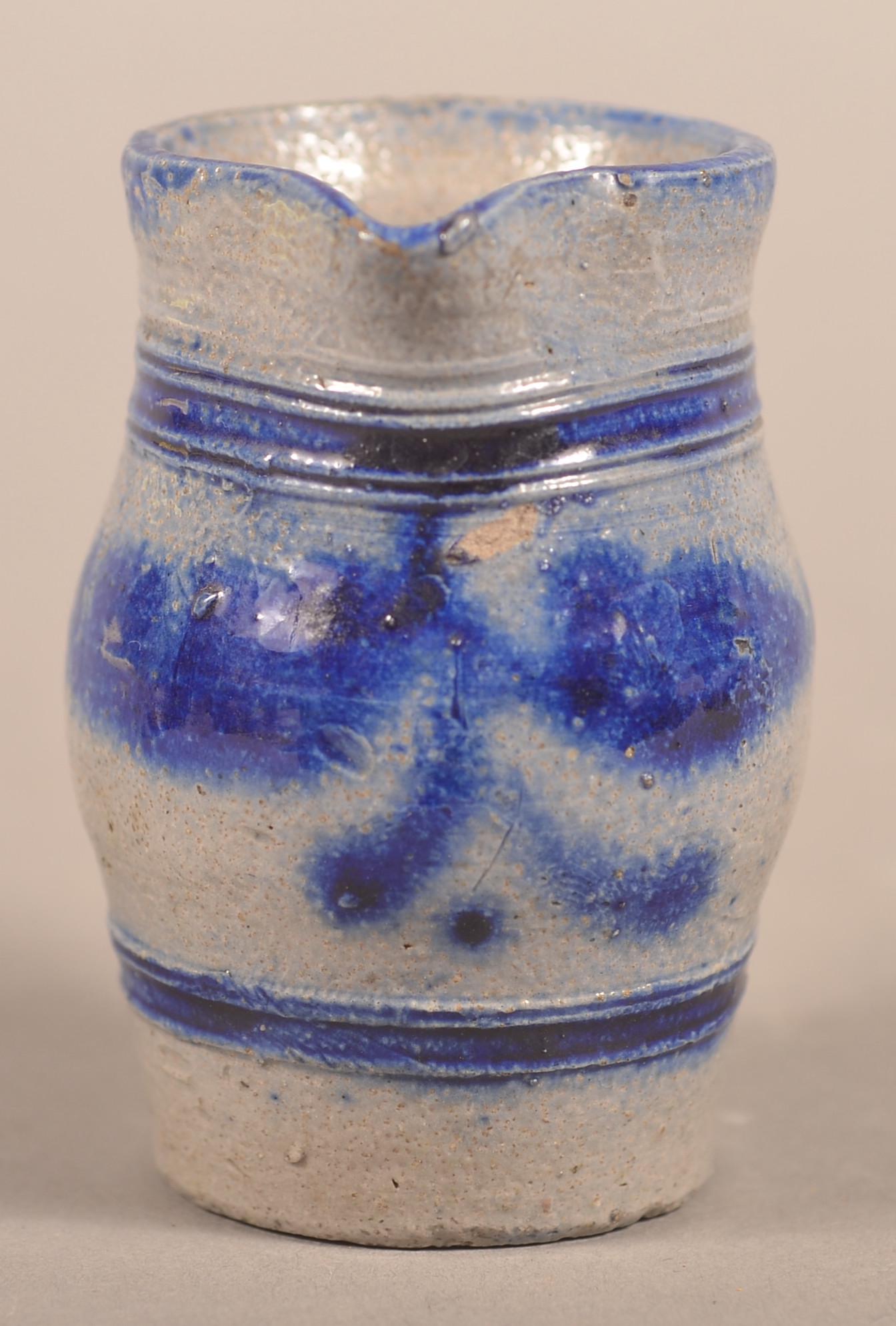Miniature Cobalt Decorated Stoneware Crock & Pitcher.: Miniature Cobalt Slip-Decorated Stoneware Crock and Pitcher. Late 19th century. Both are bulbous form with tooled bands and have stylized floral and foliate decoration. 2-1/2" and 2-3/4"h. Condition: