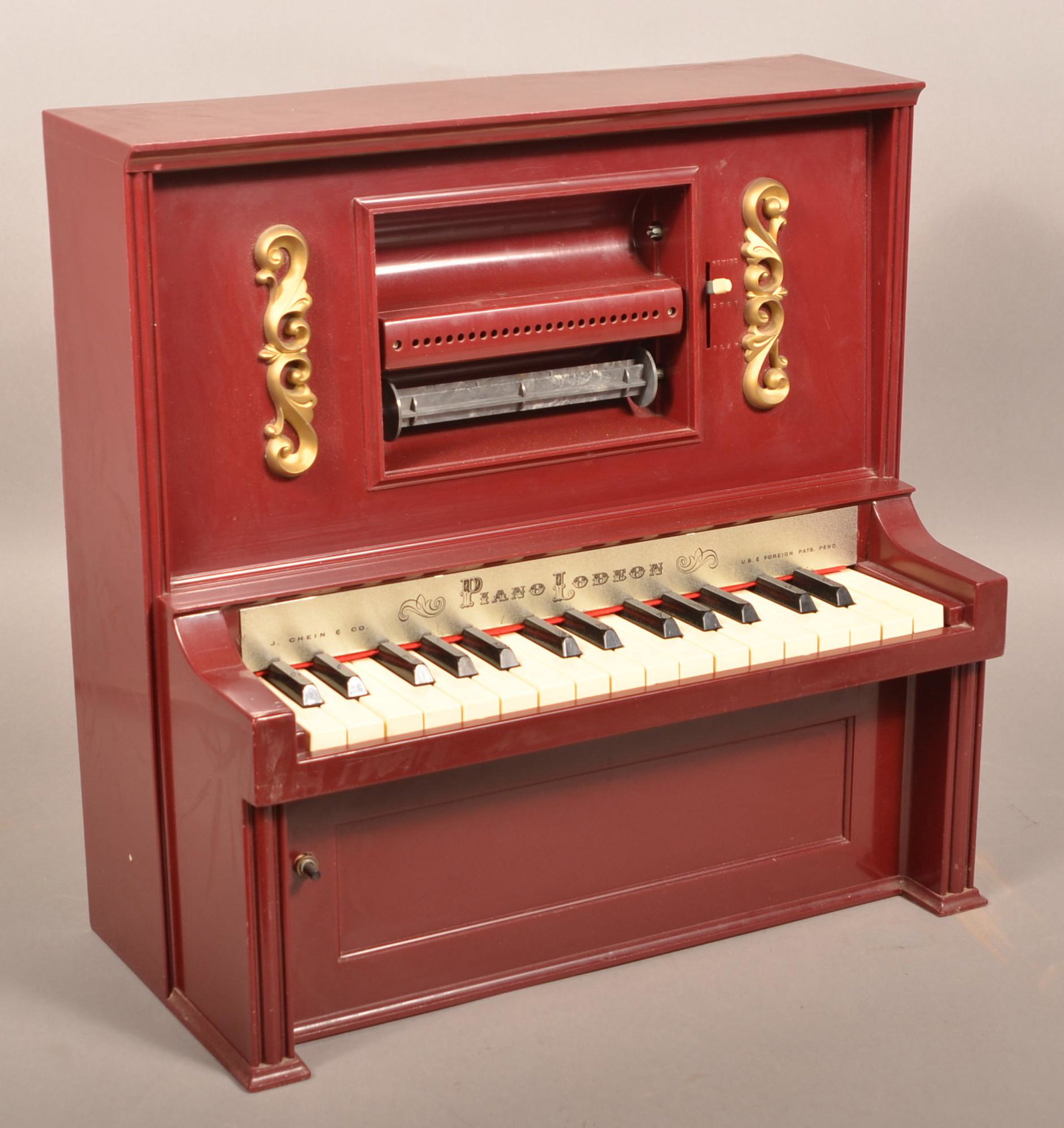 J. Chein Piano Lodeon Toy Player Piano.: J. Chein Piano Lodeon Toy Player Piano. Includes Box with Three Rolls. 20"h. x 19-1/2"w. x 10"d. Condition: Very good with use wear.