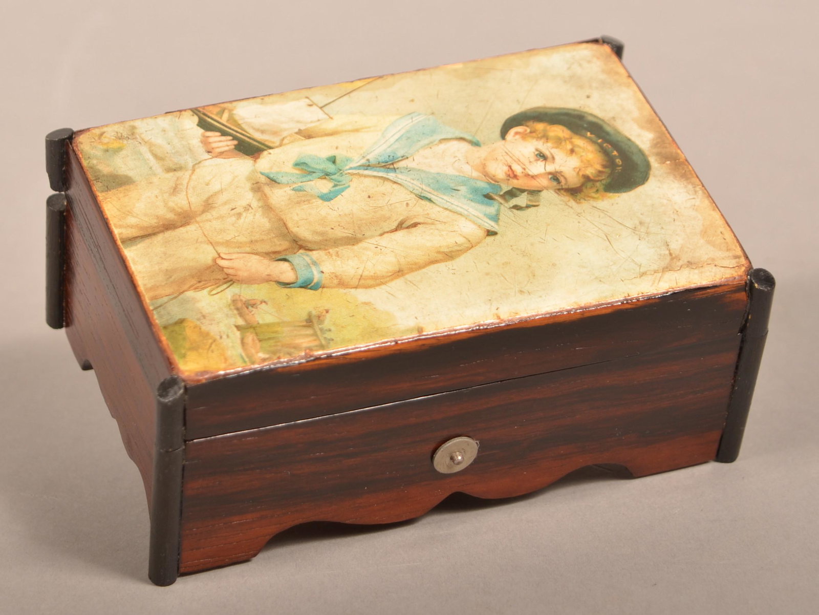 Swiss 19th Century Miniature Cylinder Music Box.: Swiss 19th Century Miniature Four Tune Cylinder Music Box. Black lacquered case with applied transfer on lid. 2-1/4"h. x 5-5/8"w. x 3-1/2"d. Condition: Good with use wear.