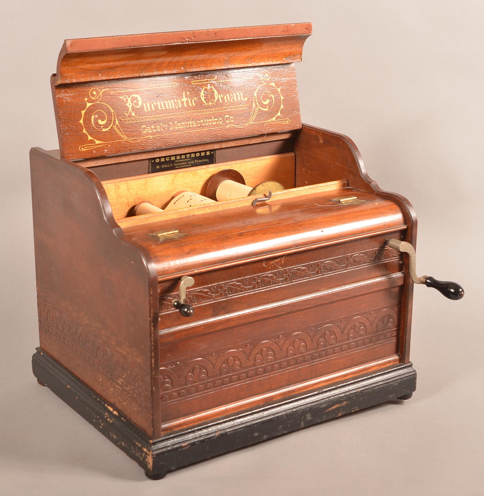 19th Century Gately Mfg. Co. Pneumatic Organ.: 19th Century Gately Mfg. Co. Pneumatic Organ. Also labeled "Orchestrone" M. Gally Inventor and patentee. Embossed walnut case with black painted trim. Includes 5 rolls. 14"h. x 16-1/2"w. x 14"d. Condi