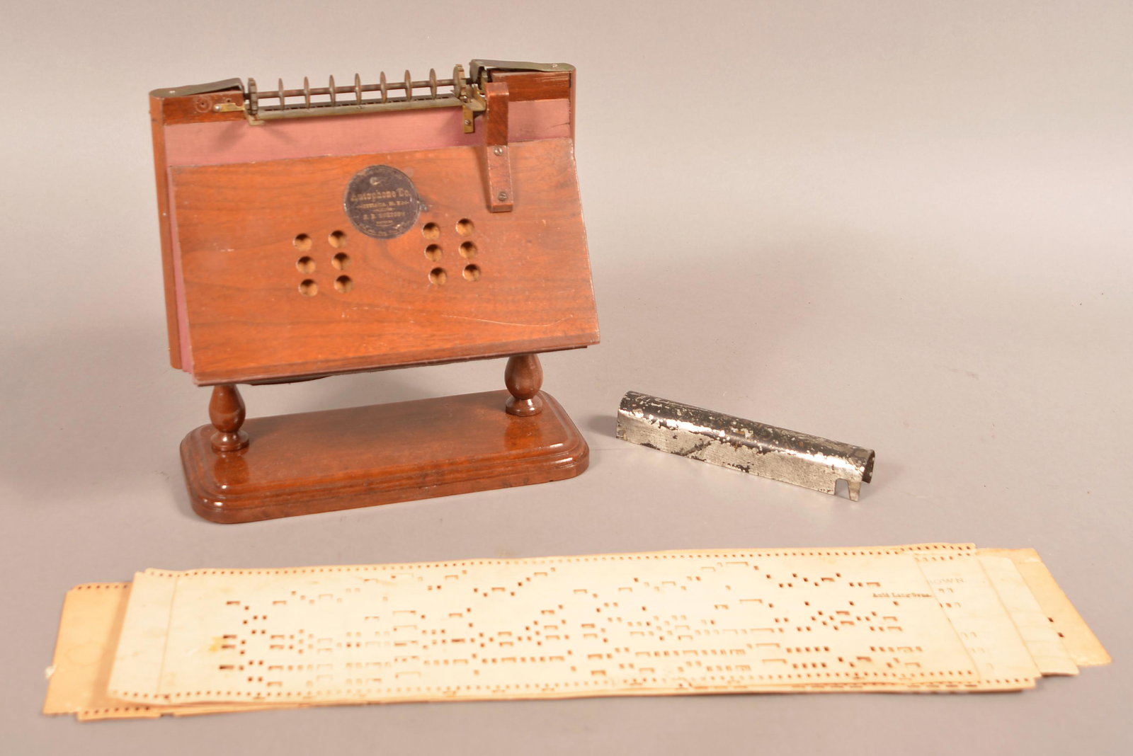 Autophone Co. Ithaca N.Y. Organette.: Autophone Co. Ithaca N.Y. Organette. (Scarce) With Four Music Strips. Including #129 Yankee Doodle, #138 John Brown & Etc. 10"h.x10"w.x5"d. Condition: Good - Very Good with wear.