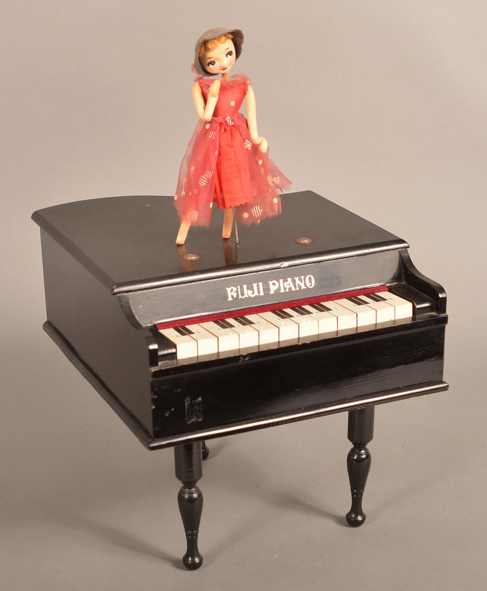 Vintage Fuji, Japan Battery Operated Toy Piano.: Vintage Fuji, Japan Battery Operated Toy Piano. With articulated dancer. 18"h. Condition: Good with wear.