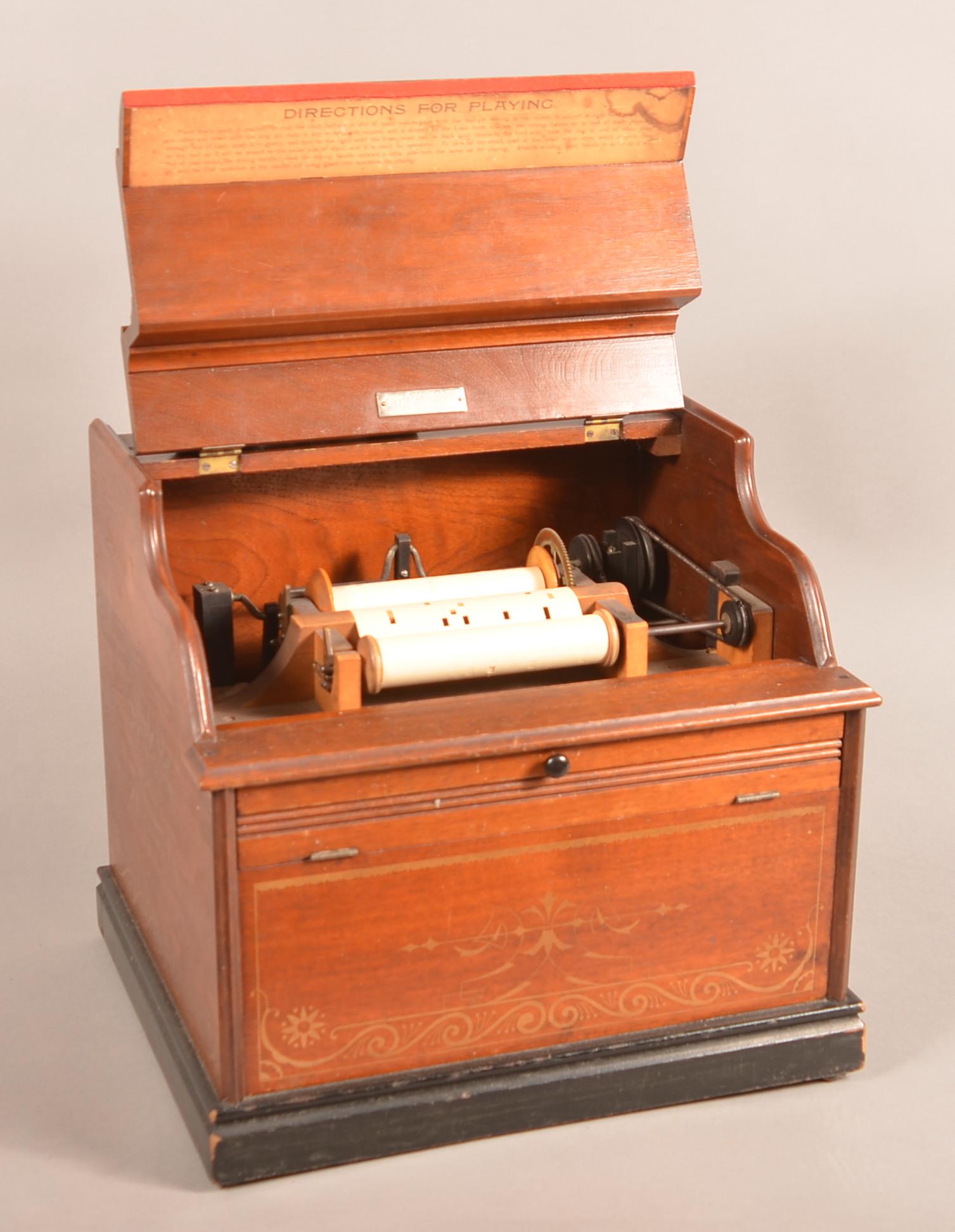 "The Improved Celestina" Victorian Organette.: "The Improved Celestina" Victorian Organette. Hand-crank roller organ with 13 paper rolls. Mahogany case with Eastlake gilt decoration and black painted trim. Retailers label "C.H. Lichty, Reading, PA