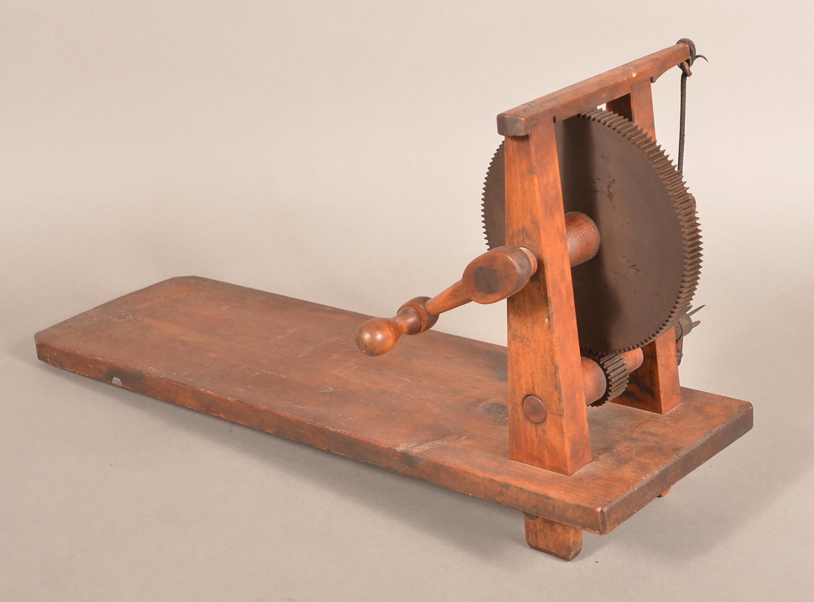 19th Century Wooden Apple Peeler.: 19th Century Wooden Apple Peeler. Crank action with cast metal gears and wood plank base. 23"l. overall. Condition: Good with use wear.