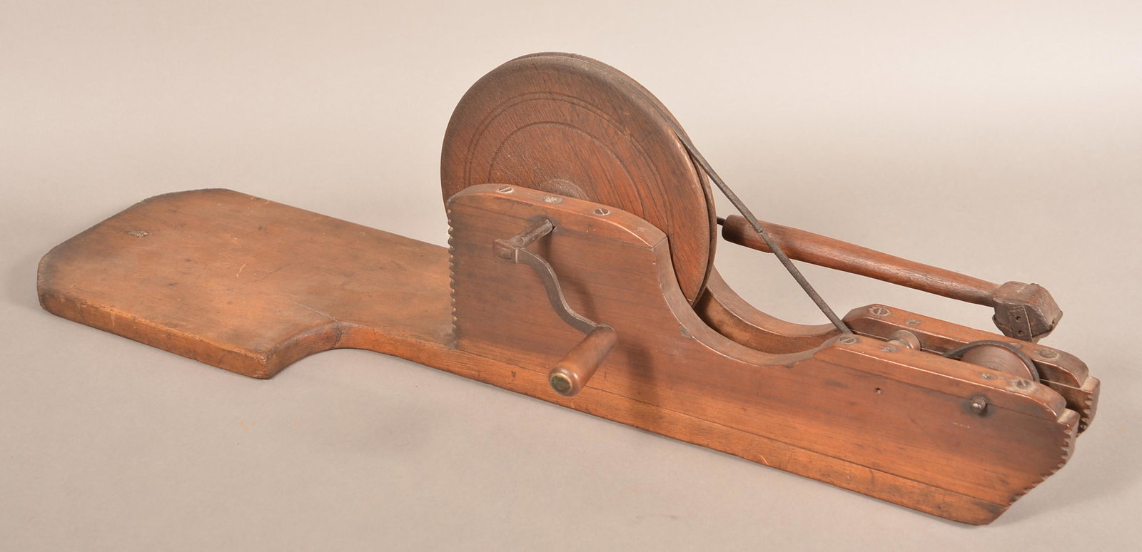 19th Century Wooden Apple Peeler.: 19th Century Wooden Apple Peeler. Crank action with plank base, gear support having notched corners. 31"l. overall. Condition: Good with use wear.