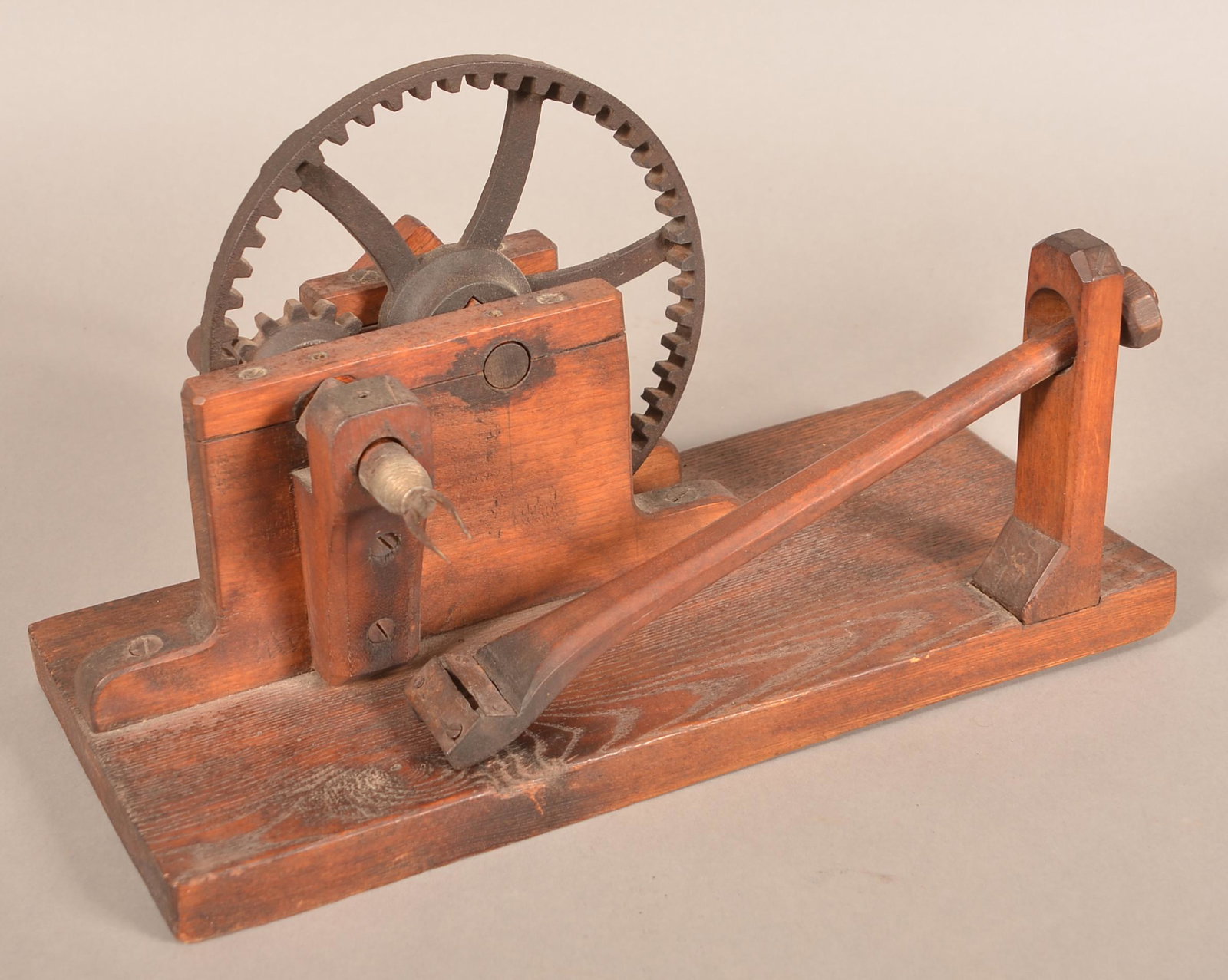 19th Century Wooden Apple Peeler.: 19th Century Wooden Apple Peeler. Crank action with cast metal gears and wood plank base. 16"l. overall. Condition: Good with use wear.