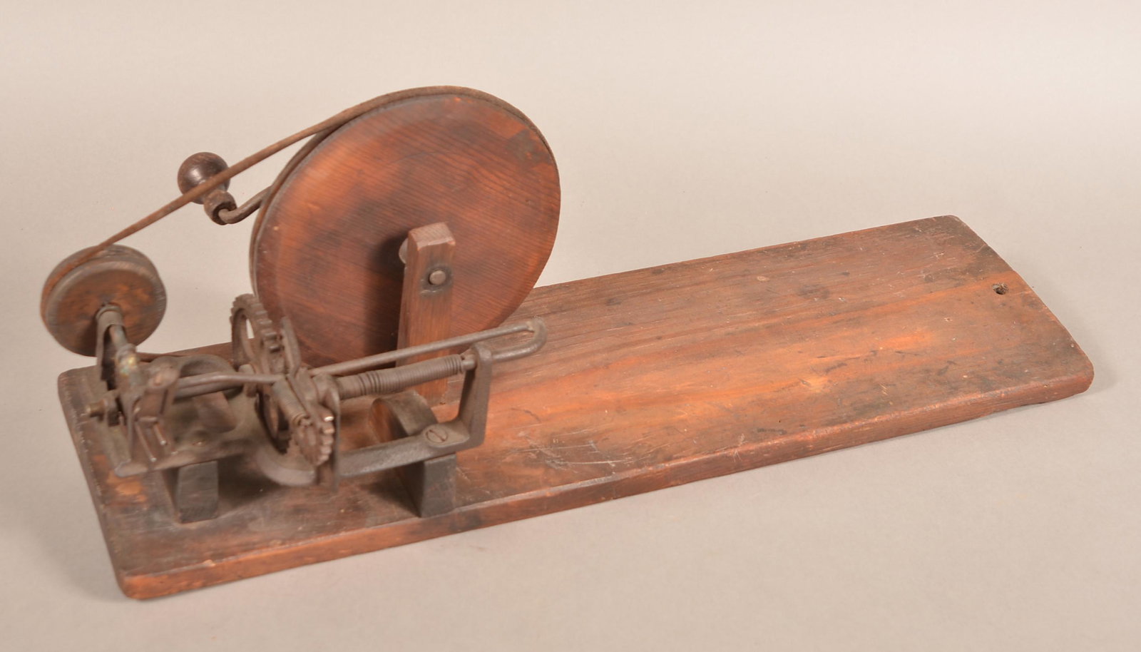 19th Century Wood and Metal Apple Peeler.: Antique Wood and Metal Apple Peeler. Crank action with plank base. 25"l. overall. Condition: Good with use wear.