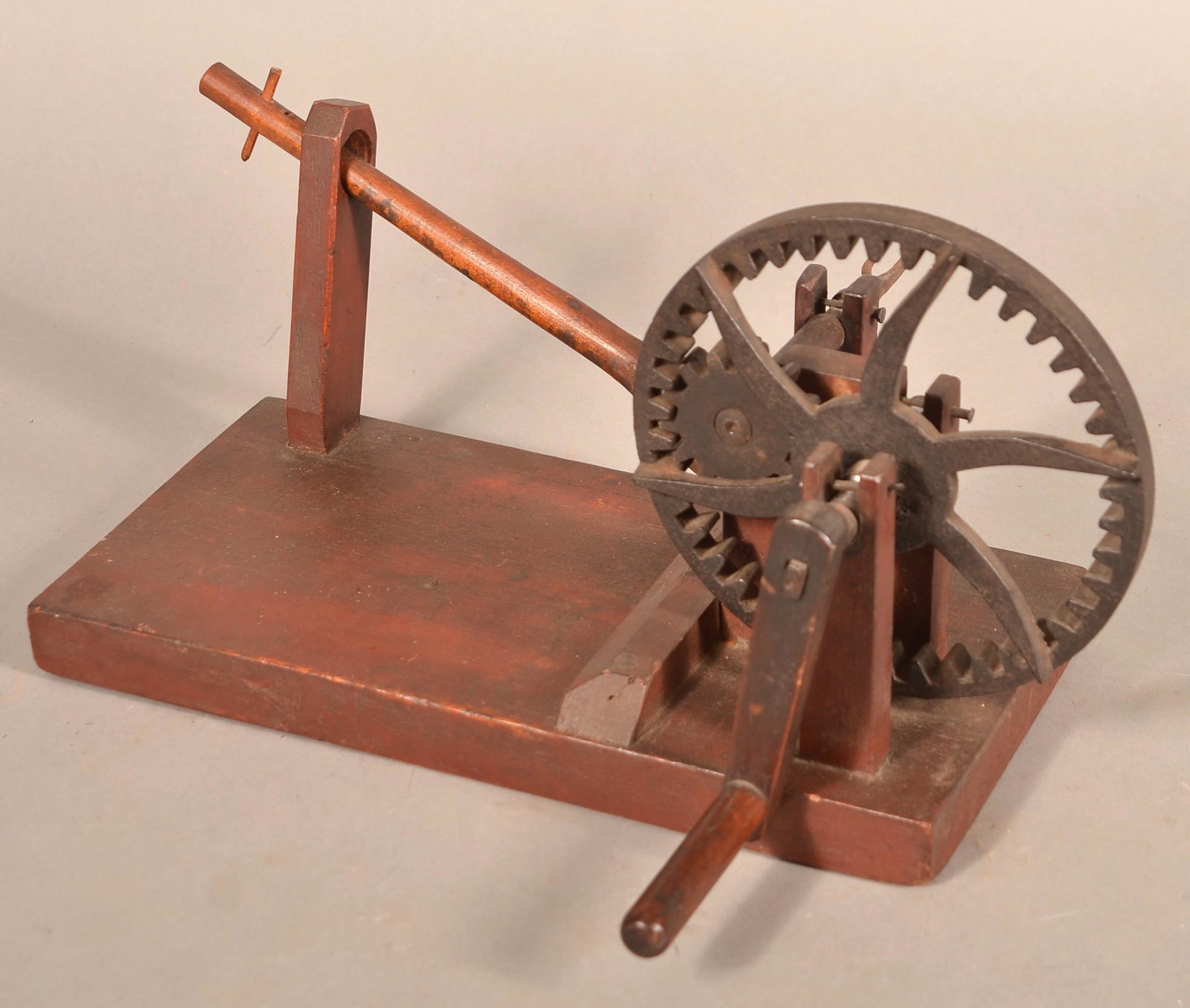 19th Century Wooden Apple Peeler.: 19th Century Wooden Apple Peeler. Crank action with cast metal gears and wood plank base. 8"h.x14.5"l.x6.5"w. without handle. Condition: Good with use wear.