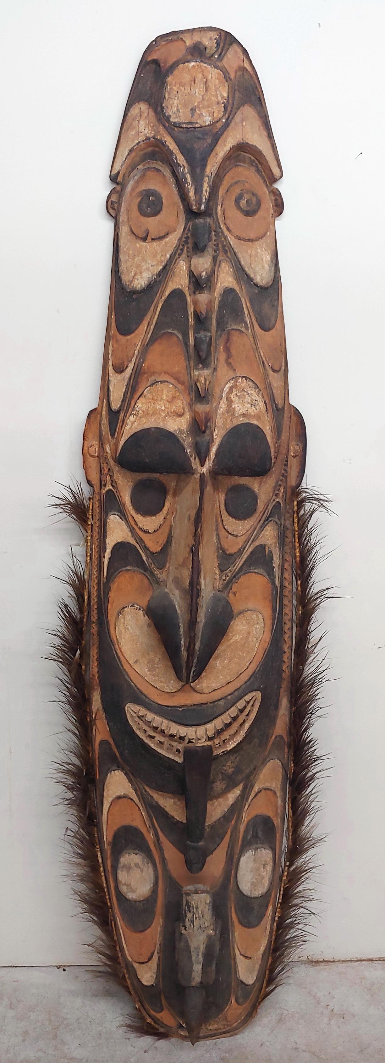 Vintage African Tribal Shield.: Vintage African Tribal Shield. Polychrome Carved Wood. 72"h.x16"w. Condition: Good, with wear.