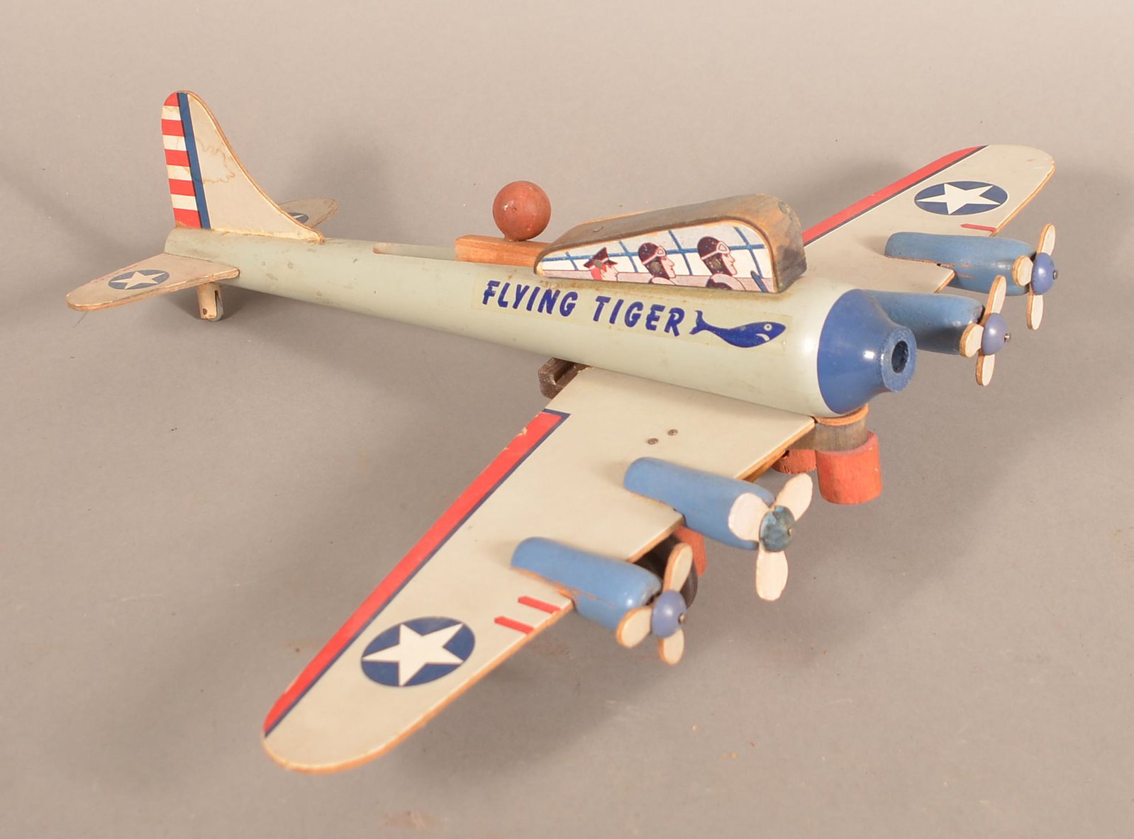 Wooden "Flying Tiger" U.S. Military Prop Plane Toy.: Wooden "Flying Tiger" U.S. Military Prop Plane Toy. 19" wingspan. Condition: Good with wear.