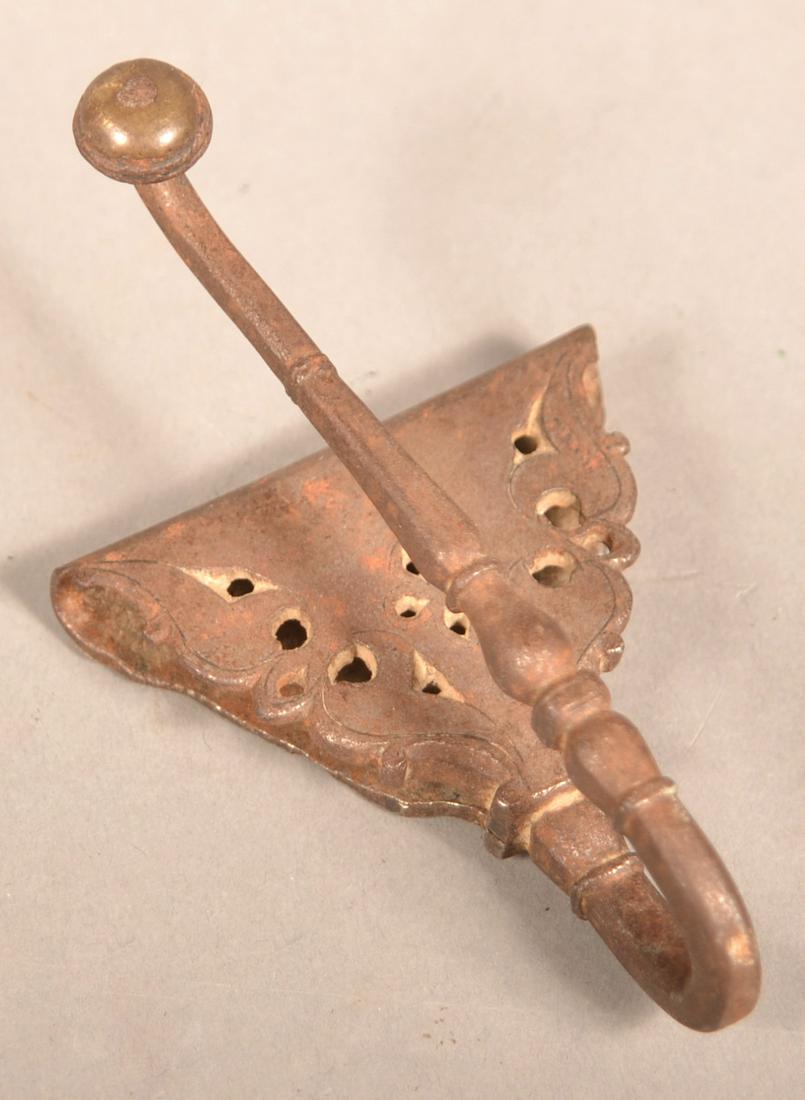 European 18th Century Wrought Iron Sword Belt Hook.: European 18th Century Wrought Iron Sword Belt Hook. Engraved foliate design with brass rosette finial. 4"h. Condition: Good with wear and light scattered pitting.