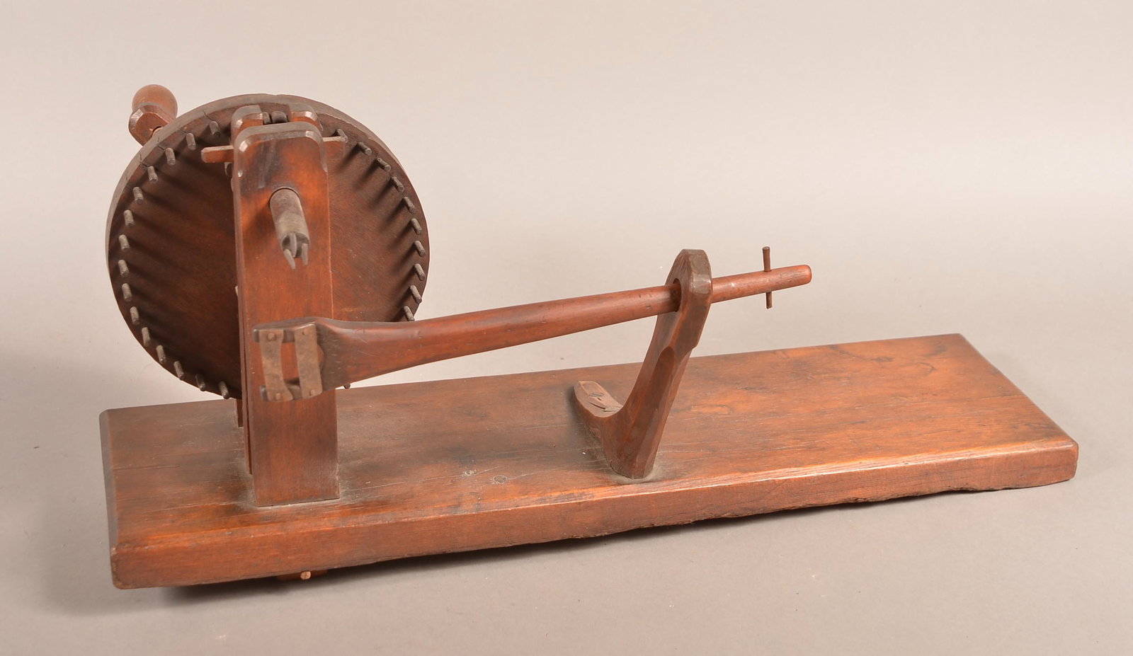 19th Century Wooden Apple Peeler with Metal Peg Gear.: 19th Century Wooden Apple Peeler with Metal Peg Gear. Crank action with plank base. 24-1/2"l. overall. Condition: Good with use wear.