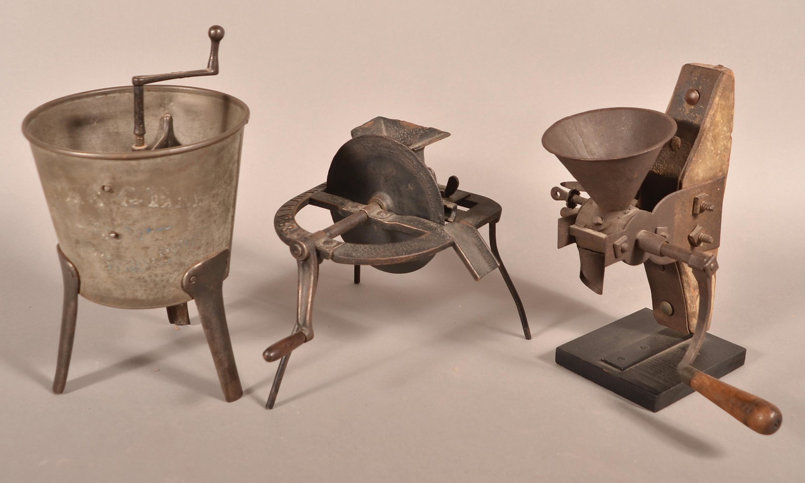 3 Pieces of Antique Metal Mechanical Utilitarian Items.: Three Pieces of Antique Metal Mechanical Utilitarian Items. Sifter, cherry pitter and a coffee grinder. Tallest 12-1/2"h. Condition: Good with scattered rust and use wear.