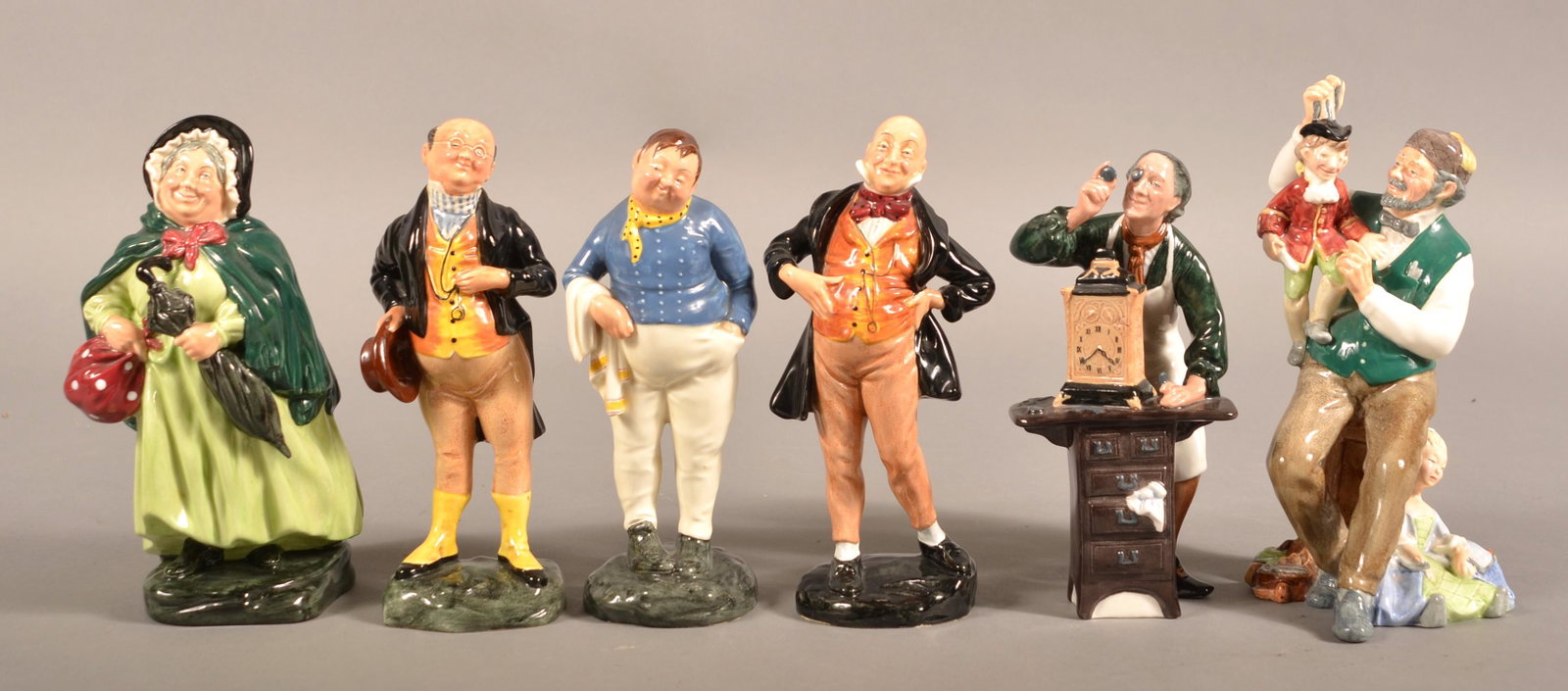 Six Royal Doulton Porcelain Figurines.: Six Royal Doulton Porcelain Figurines. "Micawber" HN-2097, "Sary Gamp" HN-2100, "The Clockmaker" HN-22791, "Pickwick" HN-2099, "The Puppetmaker" HN-2253 and "Fat Boy" HN-2096. Tallest 8"h. Condition: 