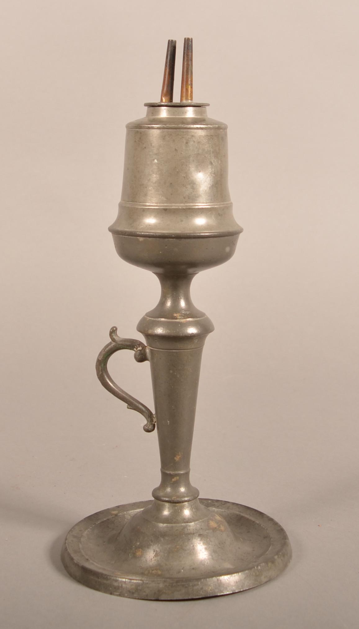 American 19th Century Pewter Whale Oil Lamp.: American 19th Century Pewter Whale Oil Lamp. Double wick burner, acorn font and pedestal base with scroll handle. Eugene and the late Vera Charles collection, Lancaster, PA. 12"h. Condition: Good with