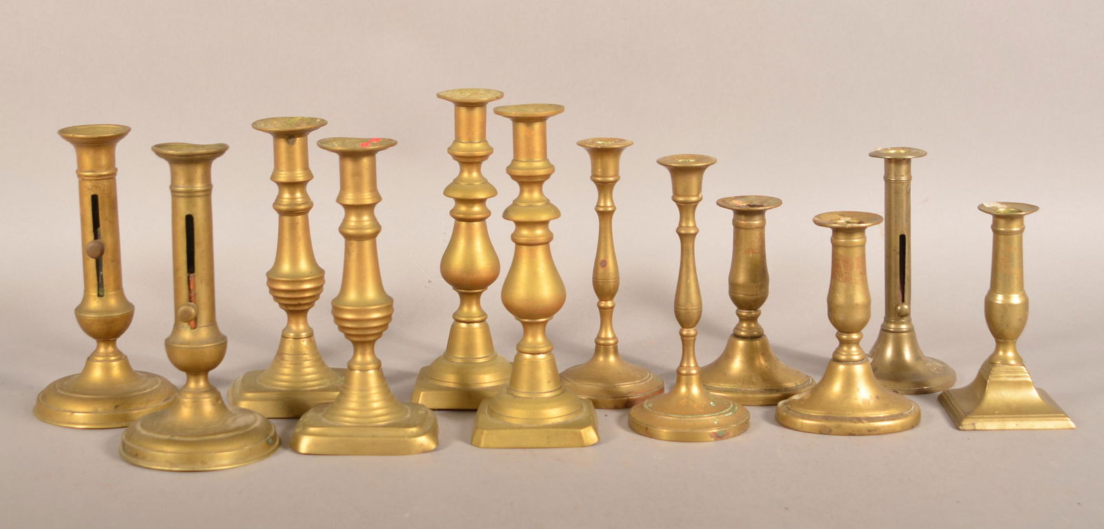 12 Antique Brass Candlesticks. (1 of 2)