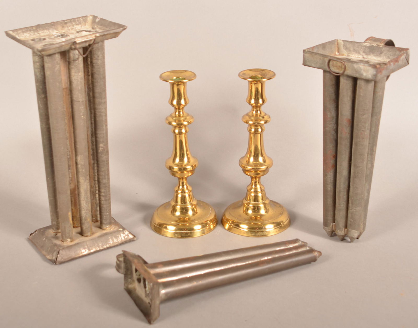 Three Tin Candlemolds and a Pair of Brass Candlesticks. (1 of 2)