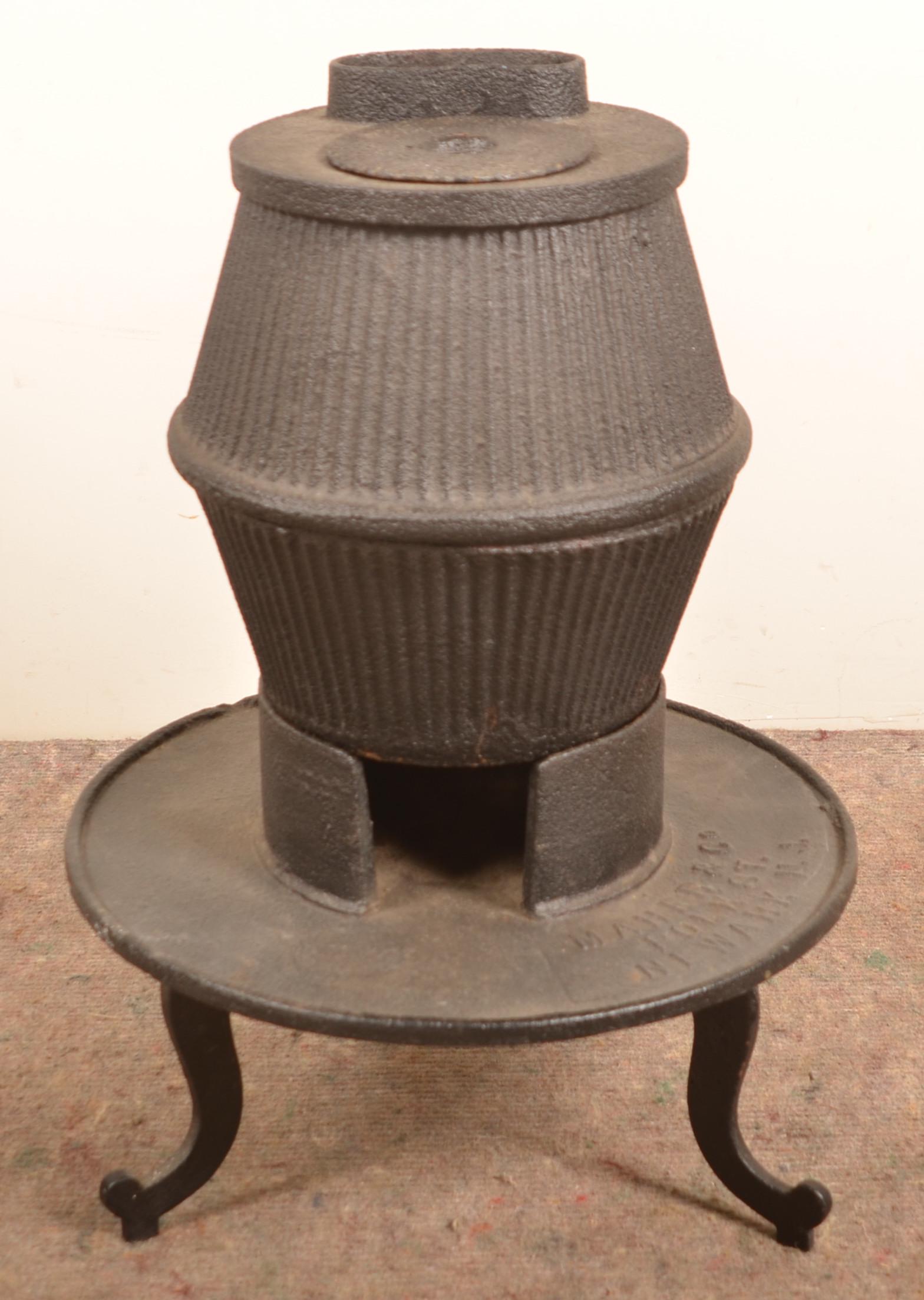 Maher & Co. Newark, NJ Cast Iron Stove.: Maher & Co. Newark, NJ Cast Iron Stove. 27"h. x 19"diam. Condition: Good with rust and pitting.