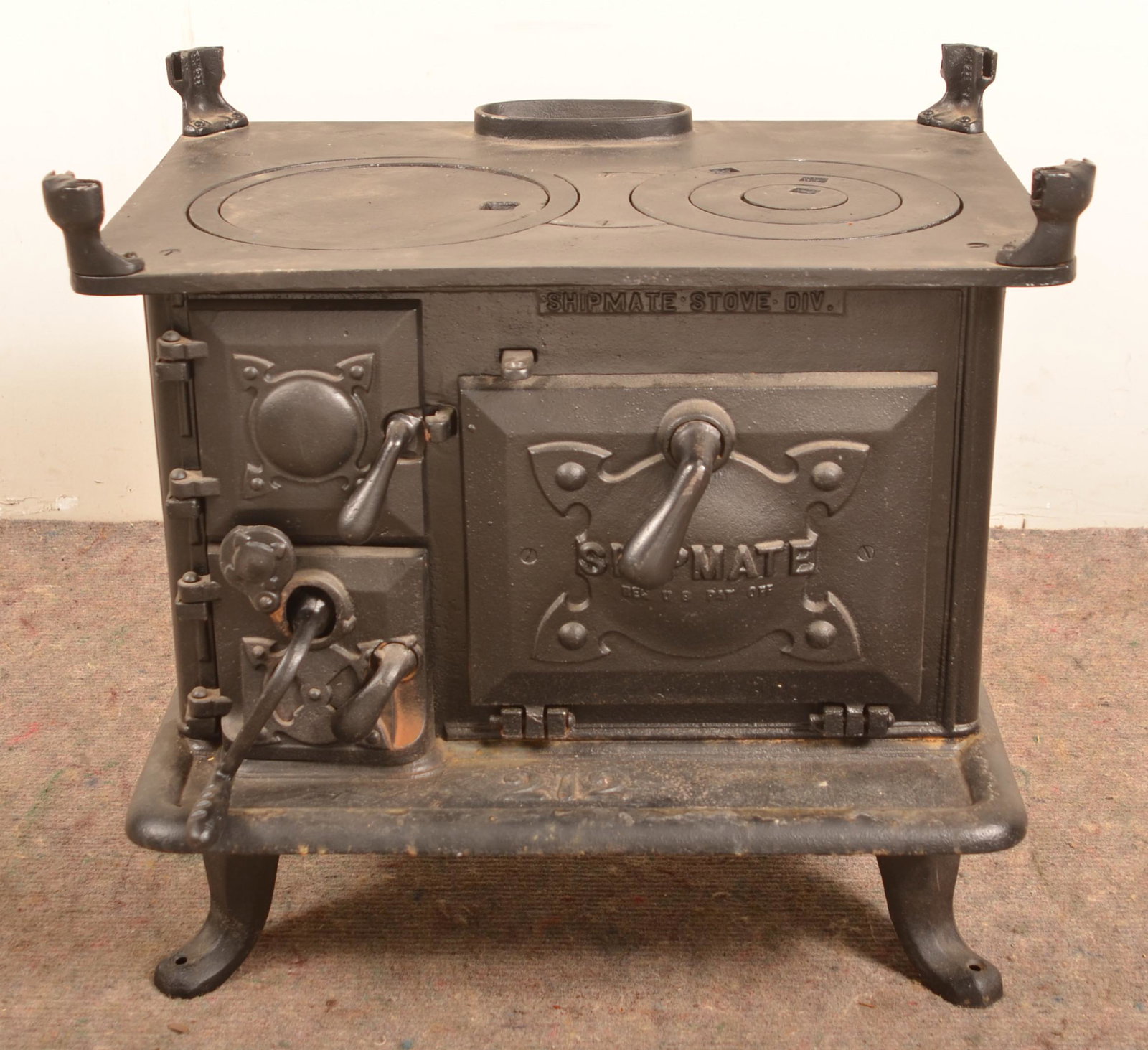 Cast Iron "Shipmate No. 212" Stove.: Cast Iron "Shipmate No. 212" Stove. 23"h. x 23"w. x 17"d. Condition: Good with rust and pitting. Missing guard rails and repaired insert.