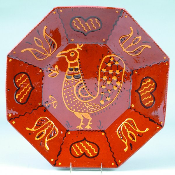 L. Breininger 1978 Redware Slip Decorated Octagon P: L. Breininger 1978 Redware Slip Decorated Octagon Plate having central bird decoration with tulips and hearts border, coggle rim, 19" x 18-3/4"dia., (very good condition).