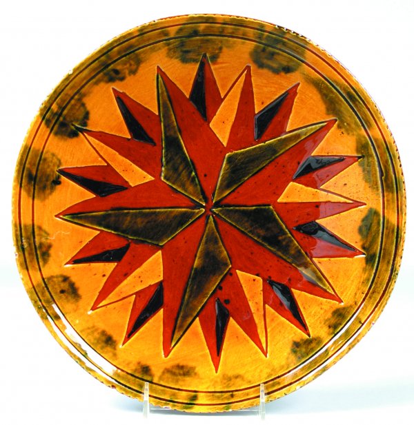 L. Breininger 1980 Redware Plate having sgraffitto: L. Breininger 1980 Redware Plate having sgraffitto multi- star decoration, coggle rim, 12-1/2"dia., (minor edge chips, otherwise very good).