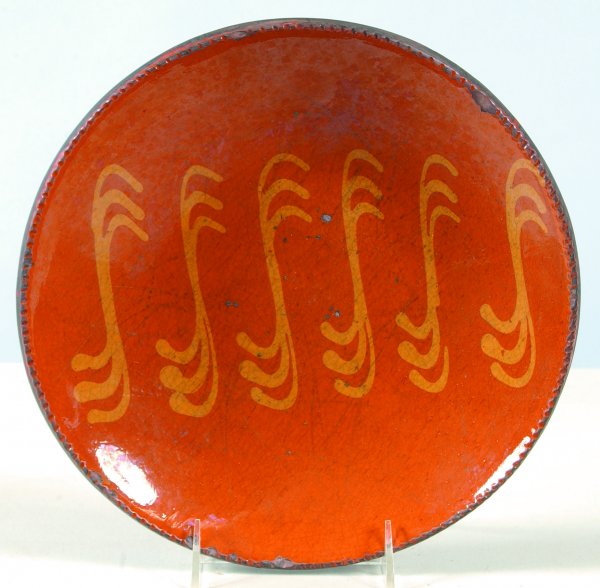 Greg Shooner 2004 Redware Slip Decorated Plate havi: Greg Shooner 2004 Redware Slip Decorated Plate having music note style decorations, coggle rim, also marked on back Warren County Ohio, 10-5/8"dia., (good condition with wear and chips).