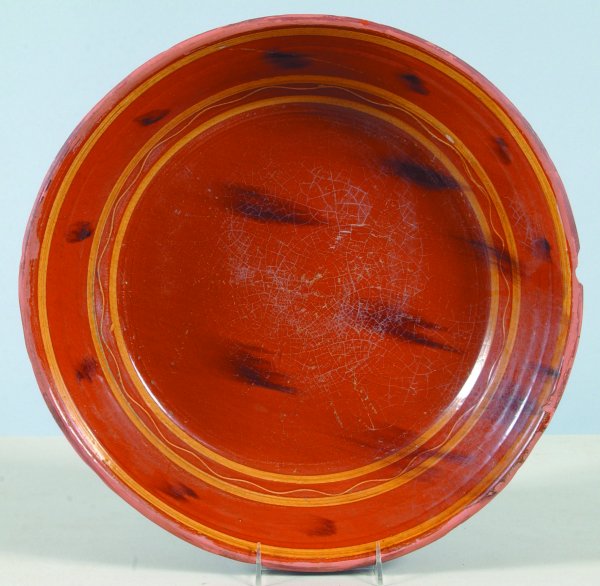 Greg Shooner 1993 Large Slip Decorated Milk Bowl h: Greg Shooner 1993 Large Slip Decorated Milk Bowl having black manganese daub and banded decorations, also incised on bottom with a stag, interior glaze only, 3-3/4"h.x17-1/8"dia., (large exterior rim 
