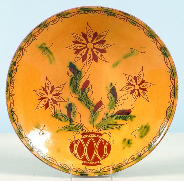 Breininger Pottery 1987 Sgraffitto Decorated Redwa: Breininger Pottery 1987 Sgraffitto Decorated Redware Charger with potted flower decoration, swag decorated border, coggle rim, 15-1/2"dia., (very good condition).